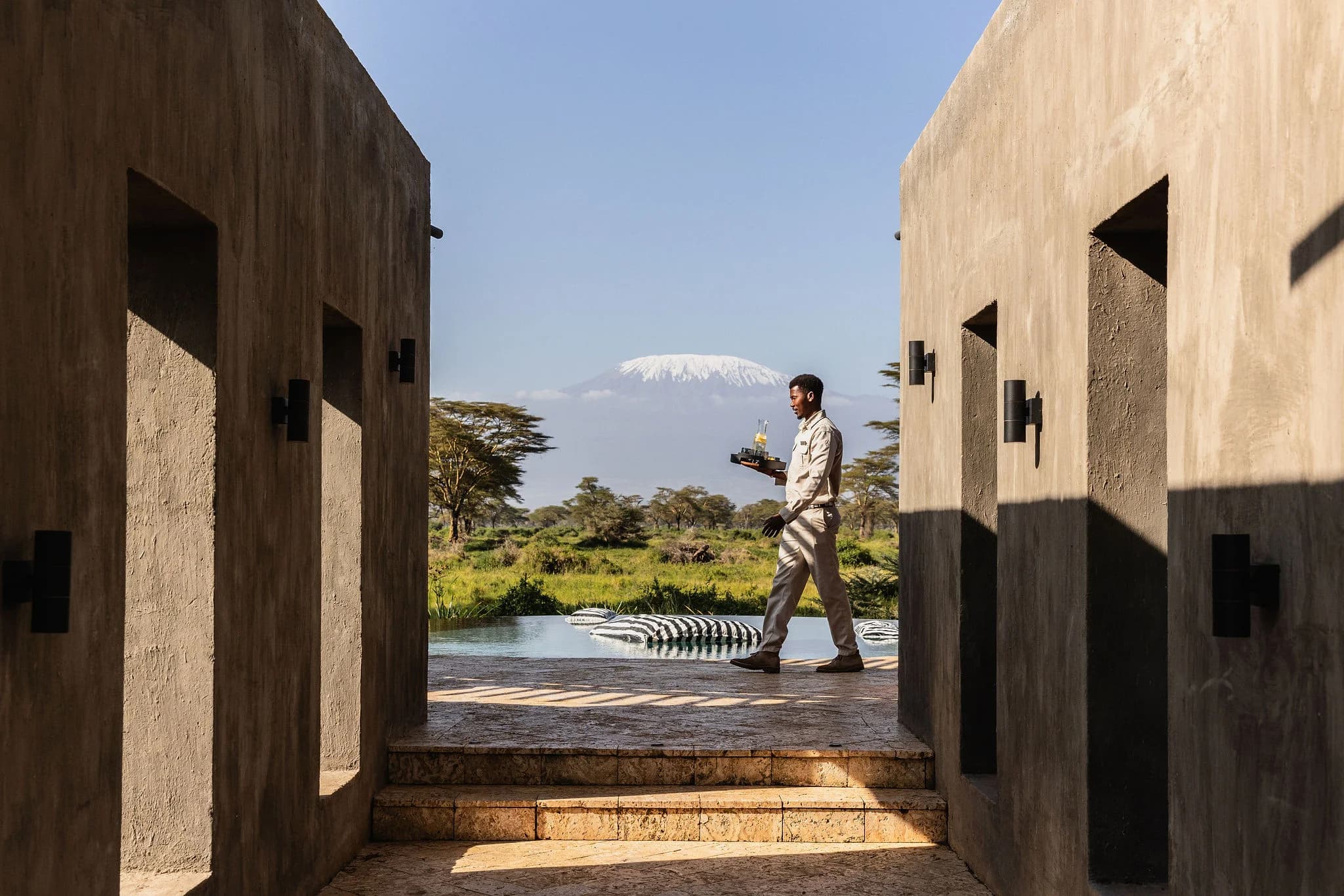 The pool at Angama Amboseli, with Kilimanjaro in the distance — Photo: Angama / Teagan Cunniffe