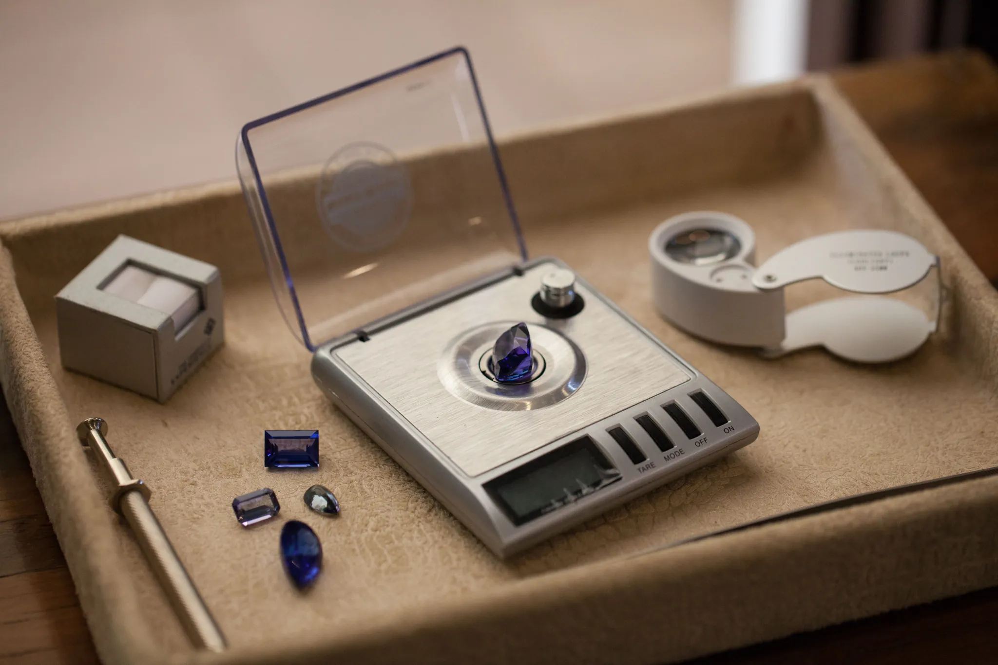 Tanzanite gemstones on a jeweller's scale at the Traders Walk boutique — Photo: Elewana Collection
