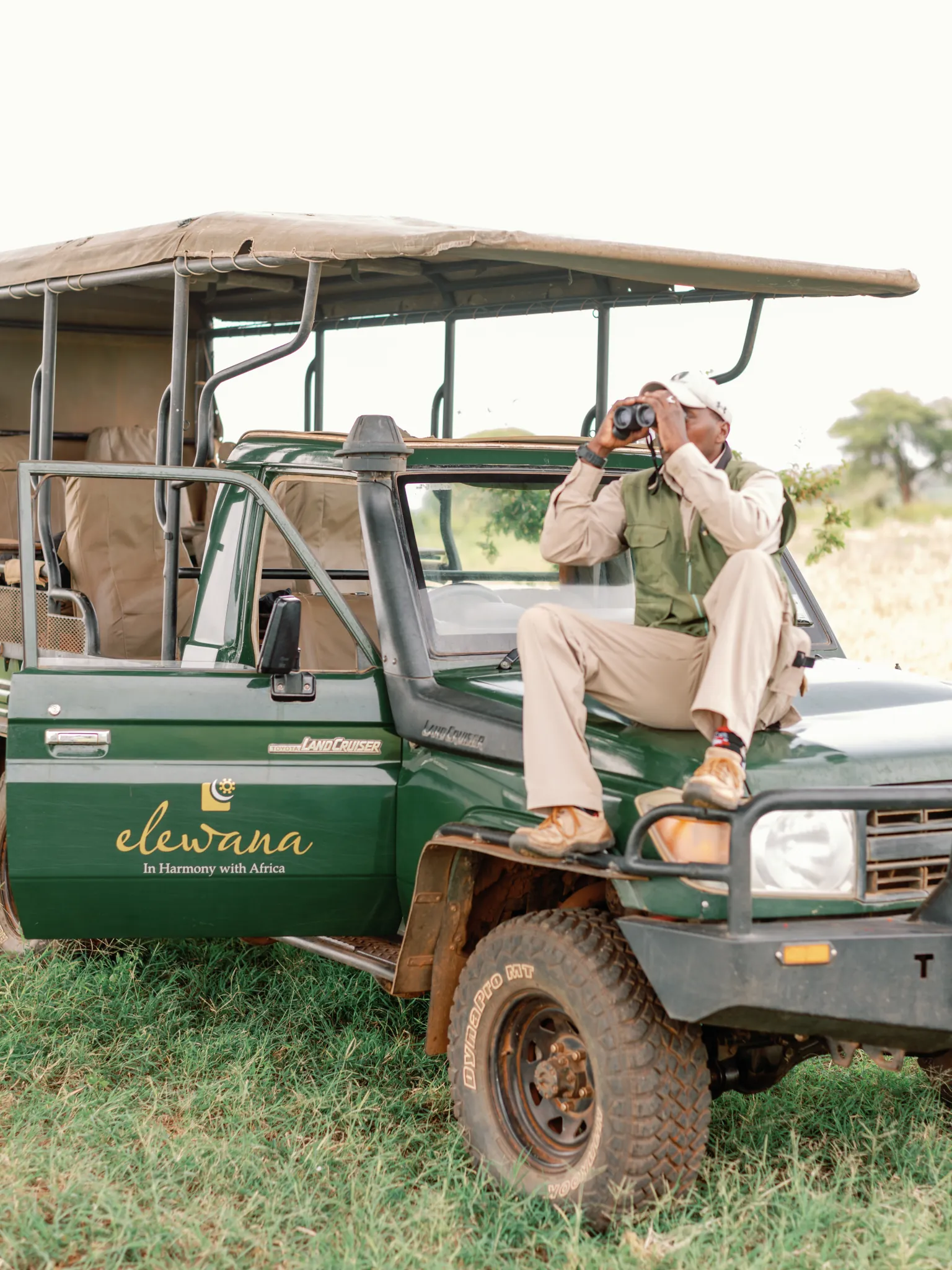 A guide scanning the bush from an Elewana game-drive vehicle in Meru — Photo: Elewana Collection / Oliver Fly Photography