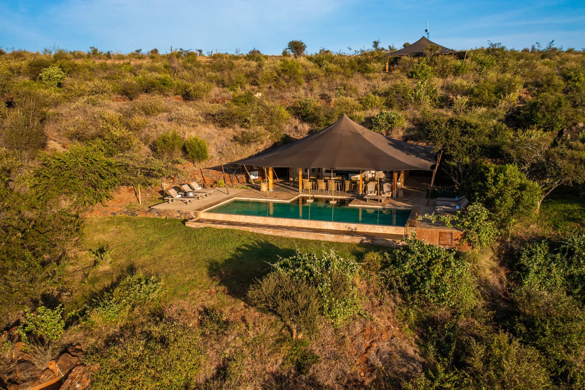 The lounge and deck at Loisaba Lodo Springs, looking out across the Laikipia plateau — Photo: Elewana Collection