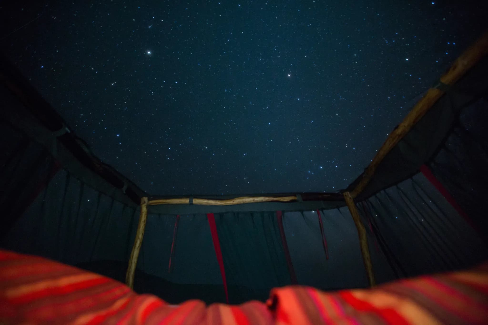 A star bed rolled out beneath the night sky at Loisaba — Photo: Elewana Collection / Silverless
