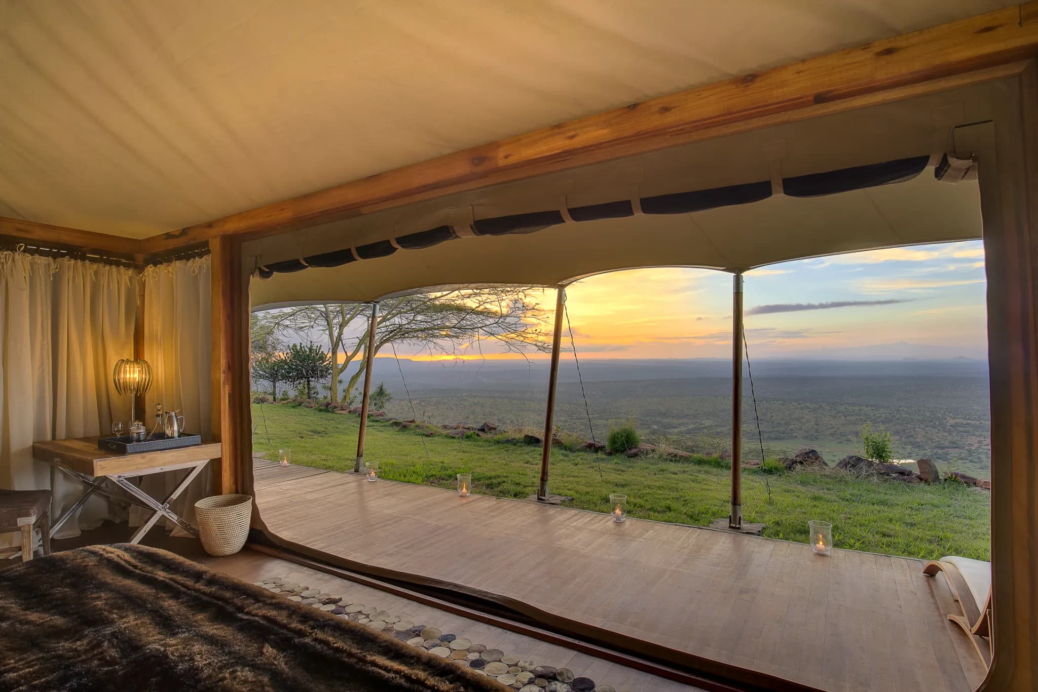 A luxury tent interior at Loisaba Tented Camp, glass-walled and open to the escarpment — Photo: Elewana Collection / Mario Moreno