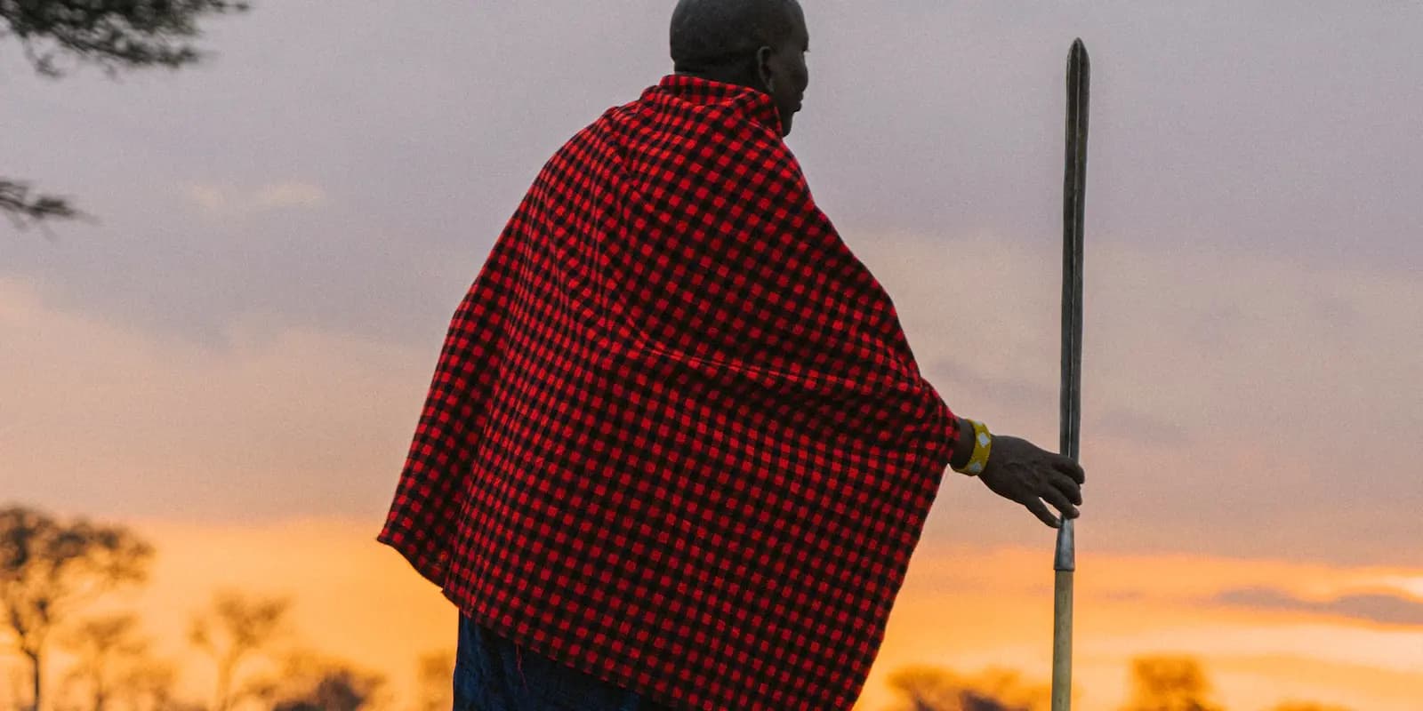 A Maasai warrior at dusk on the Serengeti plains