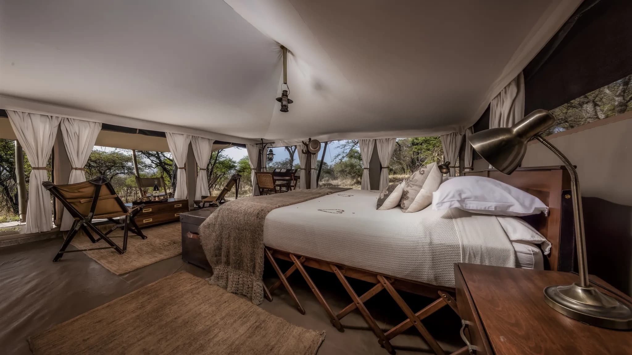 Classic tented interior at Serengeti Pioneer Camp, framed on its southern-plains view — Photo: Elewana Collection