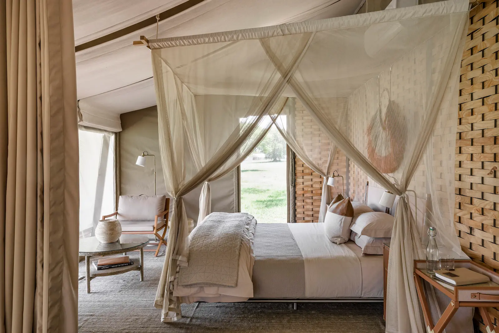 The interior of a Sabora tent — canvas, timber, and the plains beyond