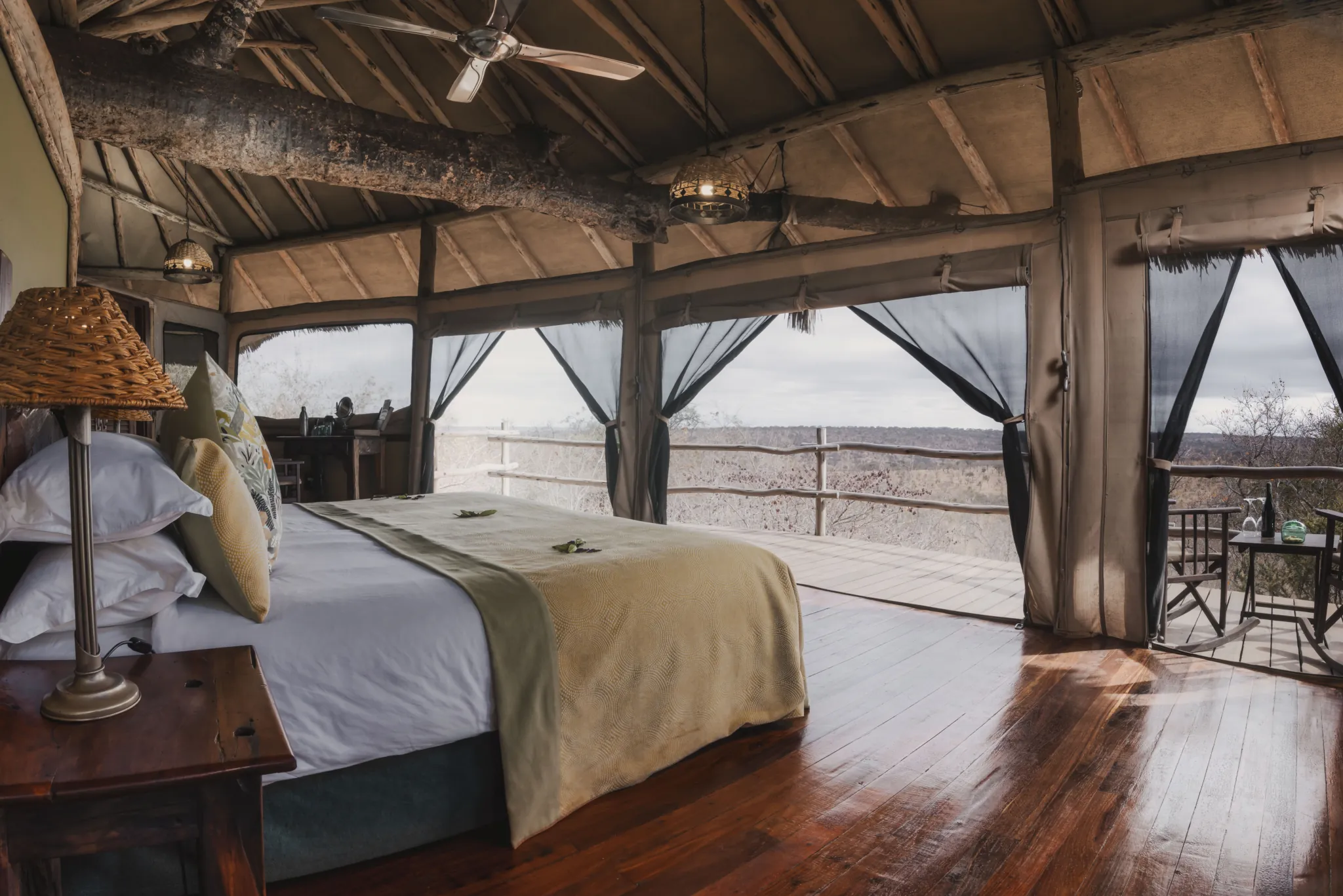 Interior of a treehouse suite at Tarangire Treetops, opening through netting to the canopy — Photo: Elewana Collection